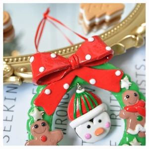 Detailed Christmas mini wreath resin ornament with red bow, penguin and gingerbread man