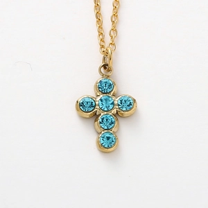 Detail of a golden cross necklace featuring six inlaid round blue crystals on a thin link chain