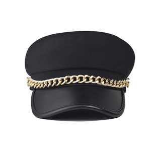 Women's black flat top baker boy hat with faux leather brim and gold chain accent