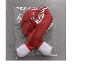Close-up of red and white Christmas wine bottle scarf with plush trim in packaging