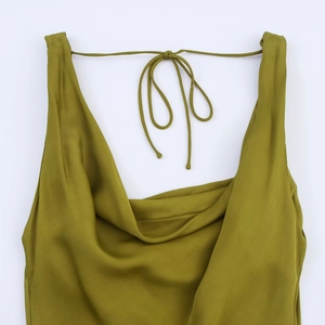 Detail of olive green satin dress featuring an elegant cowl neck and delicate straps