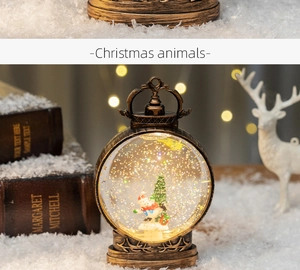 Detail view of retro bronze Christmas water lantern with glitter and deer carvings
