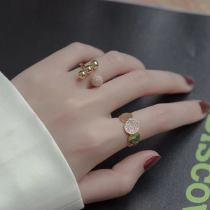 Luxurious gold-plated ring set with polished spheres and shimmering zircon pavé stones