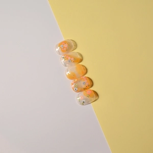 Floral embossed nail stickers with orange and blue flower patterns on gradient finish