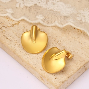 Golden 18K plated geometric leaf earrings with matte brushed finish on stone surface