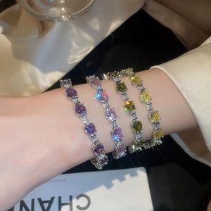Detail of four colored zircon tennis bracelets with round and baguette cut crystals