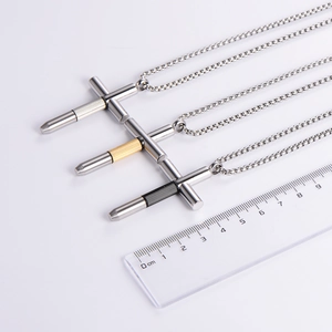 Three hip hop cross necklaces in silver, gold, and black steel finishes with measuring ruler