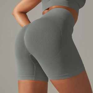 Detailed view of high-waisted grey seamless yoga shorts with peach lift and ribbed waistband