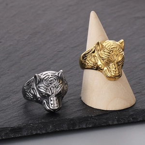 Gothic style tiger head stainless steel rings in gold and silver finish on dark stone
