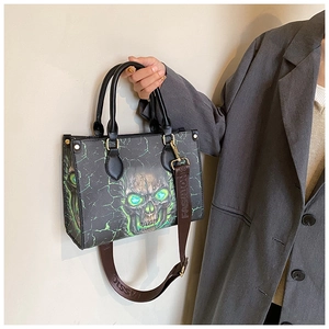 Detail of gothic tote bag with skull print, green lightning crackle and studded rivets
