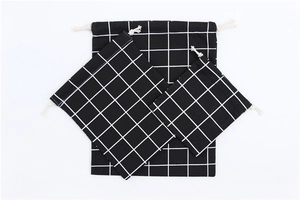 Three sizes of black and white checkered drawstring cotton linen storage bags in a set
