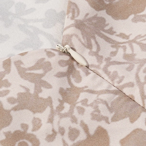 Detail of invisible zipper on vintage floral print dress fabric with close-up texture