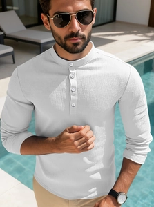 Macro shot of men's white waffle knit polo showing fine fabric texture and button detail