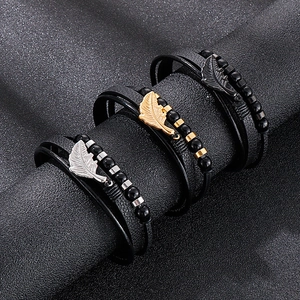Multilayer leather feather bracelets in gold, silver, and black metal accents