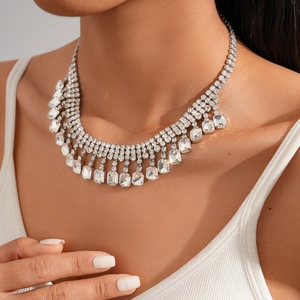 Detail of layered rhinestone necklace with rectangular crystals on a silver finish