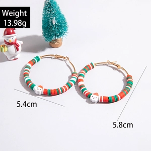 Detailed view of Christmas hoop earrings with Santa charm and red-green polymer clay beads