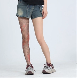 Detail of sheer nude tights featuring realistic Japanese koi and wave tattoo patterns