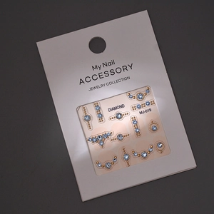 Detailed view of MJ-019 nail art stickers with light blue crystals and gold metallic beads