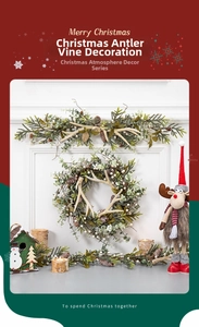 Detail of Christmas wreath and rattan with antlers, pine cones, and white berries