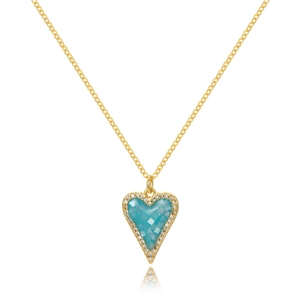 Close-up of heart pendant with turquoise gemstone and crystal border on golden chain
