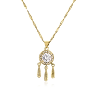 Macro detail of 18K gold plated necklace featuring a zircon pendant and three gold feathers