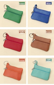 Detail of six colorful litchi grain cowhide coin purses with metal keyrings and zippers