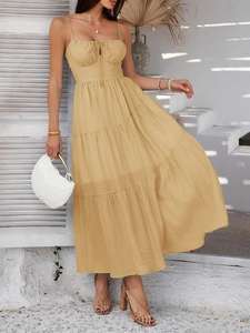 Detail of khaki tiered ruffle dress with front tie detail and spaghetti straps