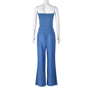 Detail of light blue strapless smocked crop top with matching wide-leg trousers on mannequin