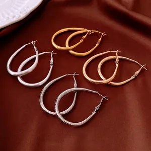 Polished and brushed teardrop hoop earrings in gold and silver finish set
