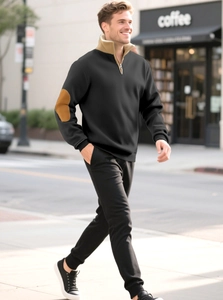 Close-up of men's black quarter-zip sweatshirt with khaki elbow patches and stand collar