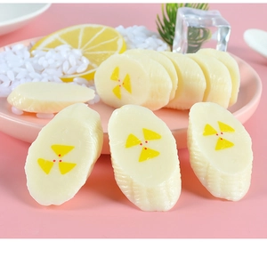 Detailed close-up of realistic PVC banana slice model in a decorative display