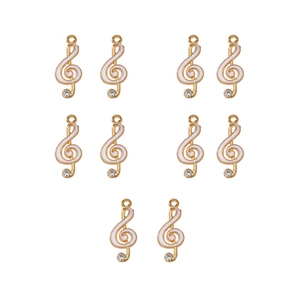 Ten pieces of gold-colored G-clef musical note charms with white enamel and clear rhinestones