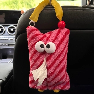 Cartoon monster plush tissue holder with red stripes hanging on car seat headrest