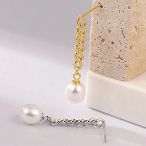 Macro view of S925 sterling silver needles and pearl chain tassel earrings details
