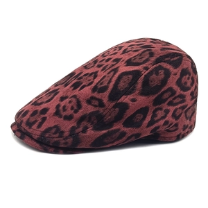 Detail view of the vintage dark red leopard print suede texture on the flat cap