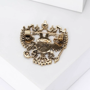 Detailed rear view showing the pin fastener on the golden Russian double-headed eagle brooch