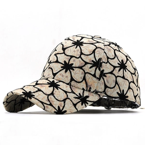 Floral print baseball cap with cream background and black outlines for sun protection