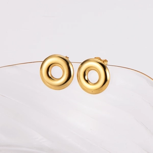 Minimalist gold round hoop earrings in 304 stainless steel on glass edge display