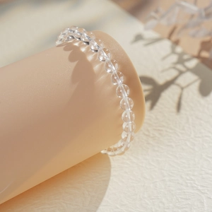 Macro detail of clear crystal beaded bracelet showing natural light reflections on beads