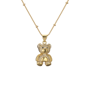 Golden bear pendant necklace fully set with white crystals and blue gemstone eyes