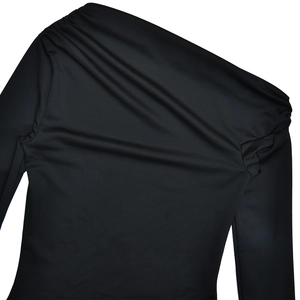 Detail of black one-shoulder long sleeve top with elegant pleated shoulder detail