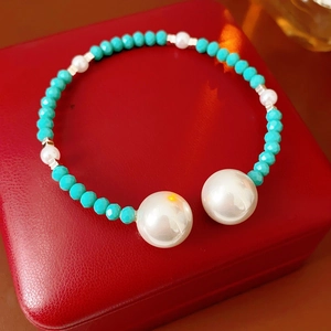 Détail d'un bracelet de perles vintage français avec perles bleues sur écrin rouge