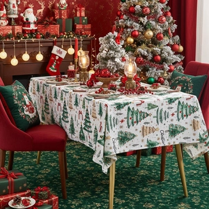 Festive Christmas polyester tablecloth with green trees and stars in a cozy home setting