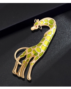 Detailed view of giraffe brooch with green enamel spots and gold-tone metallic finish