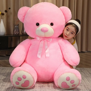 Detail of pink teddy bear plush with sweet love ribbon and heart embroidery on the feet