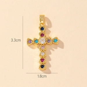 Detail shot of a gold-plated cross pendant with colorful zircon stones and size dimensions