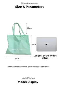 Large mint green canvas tote bag shown next to a laptop for size reference guide