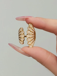 Detail of 18k gold plated fan-shaped ring with pavé zircons held between fingers