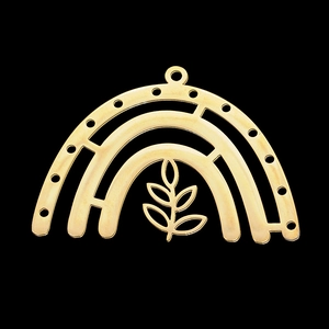 Macro view of a golden arch-shaped hollow pendant with a stylized leaf pattern inside