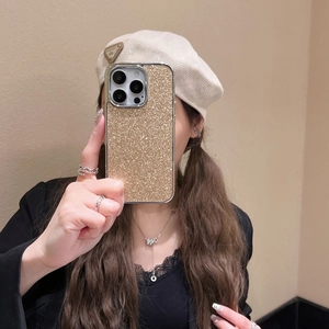 Mirror selfie showing a luxury gold glitter plating case for iPhone with shiny finish